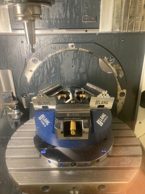 5-axis vise from LANG Technik machines blank in a machine tool